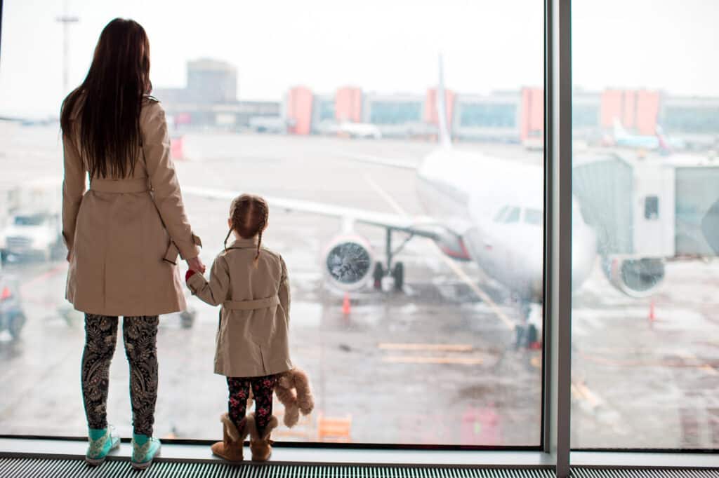 Mother and child at the airport working through an international custody dispute.